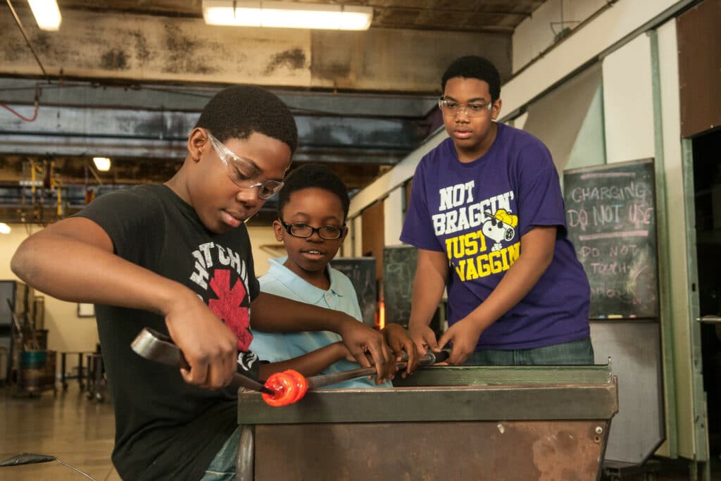 youth apprentices working with glass