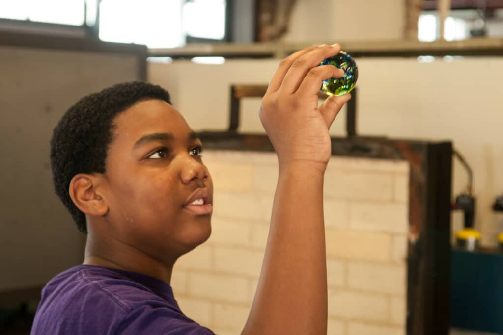 youth apprentices working with glass