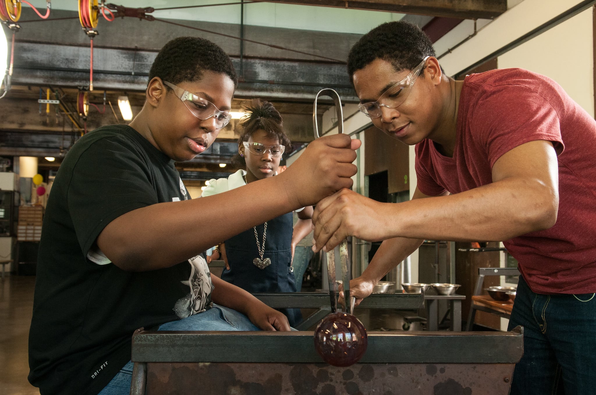 youth apprentices working with glass