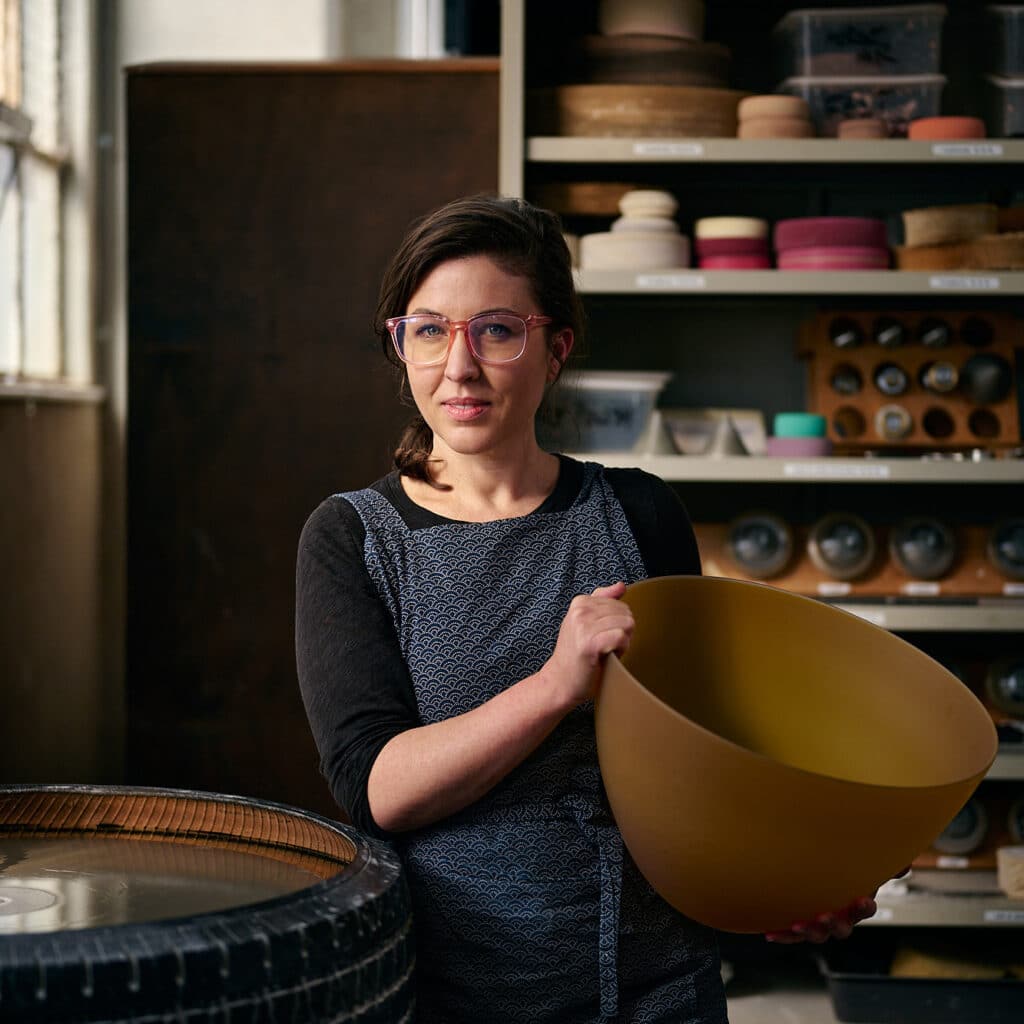 Mel Douglas holding her art