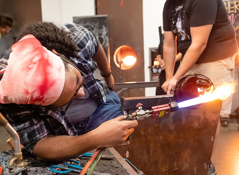 artist using flame blower