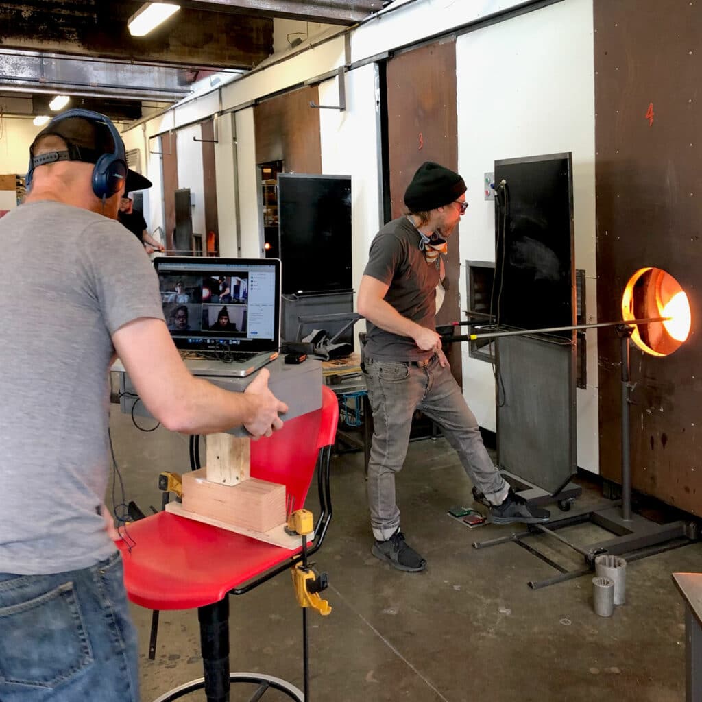 person at kiln and person working at computer