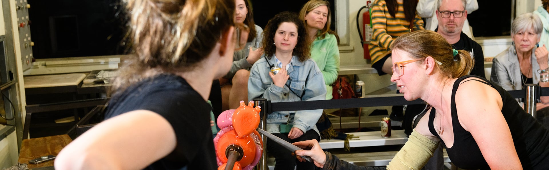 people watching glassblowing demonstration