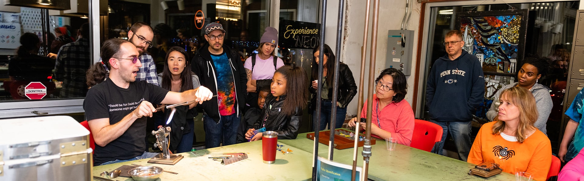 people watching a flameworking demonstration