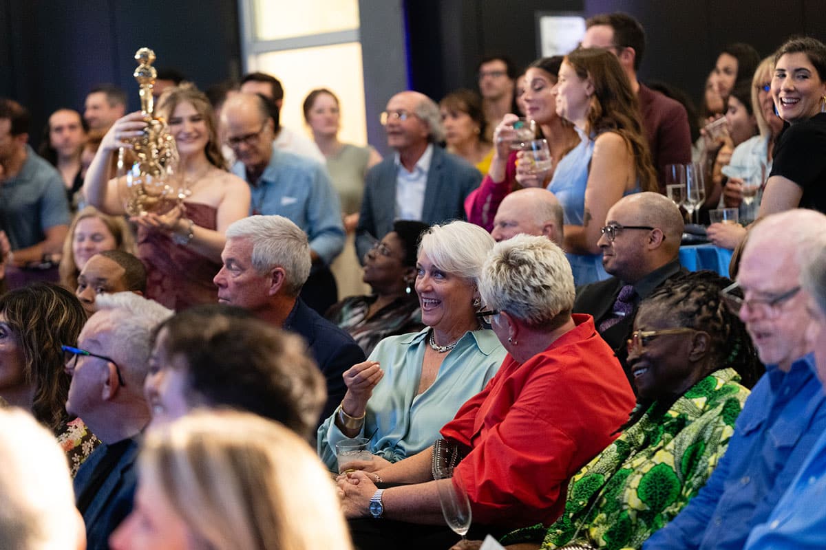 Audience watching the live auction at Art on Fire