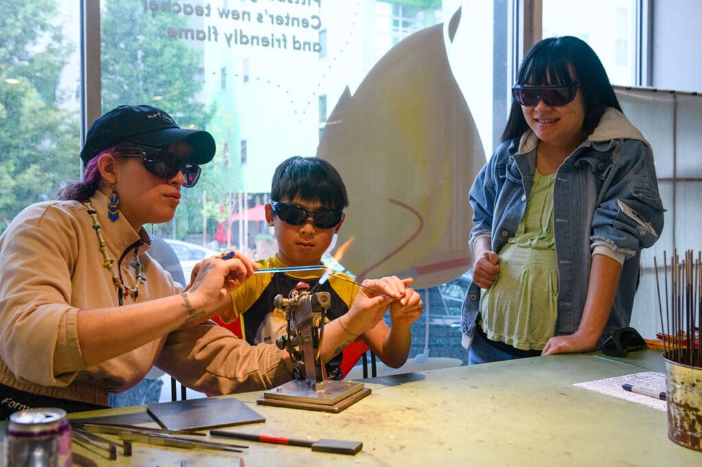 Crafting the Future artist teaching a flameworking activity at Pittsburgh Glass Center