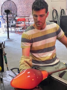 Josh Raiffe blowing glass