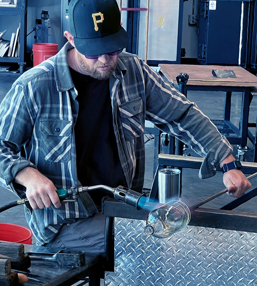 Jason Forck creating glass bottles in the hot shop